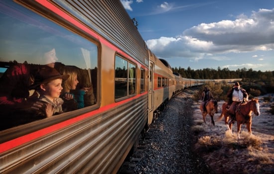 Kids looking outside the window of the Grand Canyon train